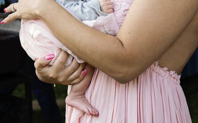 Wedding guest holding baby