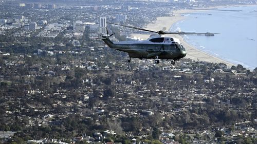 Marine One, with President Donald Trump aboard, flies above devastation caused by wildfires, in areas of Los Angeles, Friday, Jan 24, 2025. (Mandel Ngan/Pool via AP)