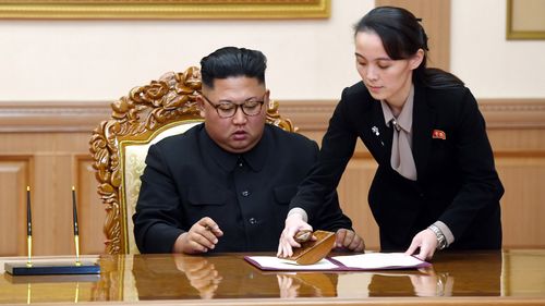 In this Sept. 19, 2018, file photo, Kim Yo Jong, right, helps her brother North Korean leader Kim Jong Un sign a joint statement following the summit with South Korean President Moon Jae-in at the Paekhwawon State Guesthouse in Pyongyang, North Korea. 