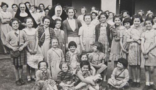 Yvonne Radzevicius, standing third from left in a picture loaned to the On Their Own project. After WW2, over 3000 children young as three were sent to Australia.