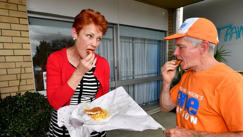 Hanson and Roberts eat fish and chips outside her former fish and chips shop in the suburb of Silkstone in Ipswich. (Image: AAP)