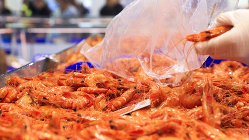 SYDNEY, AUSTRALIA - DECEMBER 23: A general view of prawns at the Sydney Fish Market on December 23, 2021 in Sydney, Australia. The Sydney Fish Market experiences its busiest trade over the Christmas week including the 36 hour marathon from 5am on the 23rd December until 5pm Christmas Eve, with over 350 tonnes of seafood expected to be sold at the event during the non-stop trading period. (Photo by Jenny Evans/Getty Images)