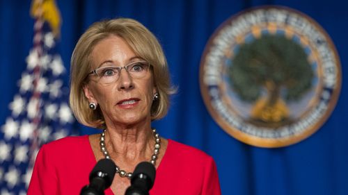 Education Secretary Betsy Devos described Donald Trump's rhetoric as an 'inflection point' in her resignation decision.