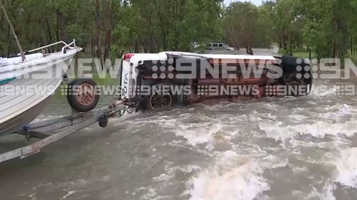 One of the vehicles flipped after driving on a flooded road an hour outside of Darwin. 