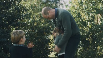 Prince William tickling Princess Charlotte as Prince Louis screams with joy