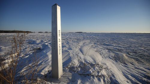 FILE - A border marker, between the United States and Canada is shown just outside of Emerson, Manitoba, on Thursday, Jan. 20, 2022.  (John Woods/The Canadian Press via AP, File)