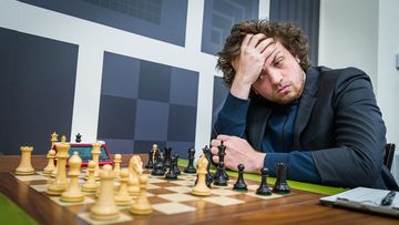 Hans Niemann, pictured playing chess in St. Louis on September 11, has been accused of cheating by five-time world champion Magnus Carlsen. Niemann denies the accusation.