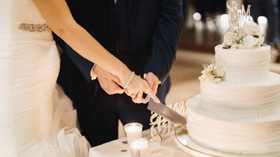 Couple cutting wedding cake