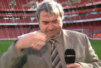 <b>It's not always fun and games being a sports reporter, as a British football commentator recently found out.</b><br/><br/>The BBC's Jonathan Pearce was preparing for a pre-match report from Arsenal's Emirates Stadium when he received an unexpected soaking from the pitchside sprinklers.<br/><br/>The unwelcome shower didn't put the veteran commentator off his game, however, and he was able to see the funny side as he delivered his report - albeit with a soaking wet suit.<br/><br/>We've said it before, sports reporting often presents dangers. Just take a look at these videos.<br/>