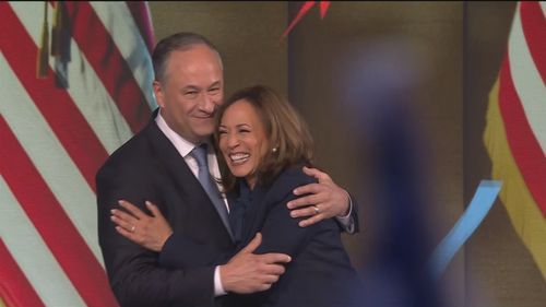 Kamala Harris is hugged by her husband Doug Emhoff.