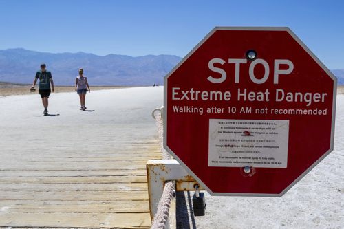 A sign warns people of extreme heat in multiple languages on Tuesday, July 11, 2023, in Death Valley National Park, Calif. 
