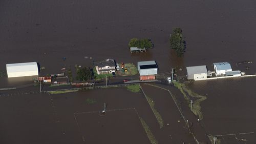 NSW Premier Dominic Perrottet surveys the floods in the Hunter Region in a chopper this morning with Minister for Emergency Services and Resilience and Minister for Flood Recovery Steph Cooke. Pictured is flooding in and around Maitland. Picture: David Swift