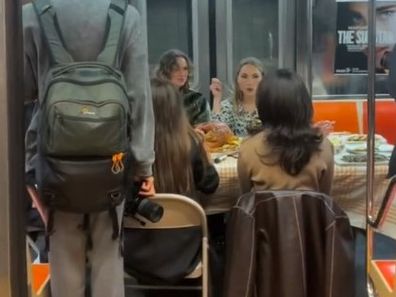 A group of friends celebrate Thanksgiving on the subway in New York