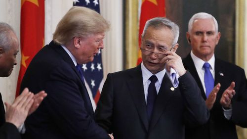 President Donald Trump shakes hands with Chinese Vice Premier Liu He before signing "phase one" of a US China trade agreement.