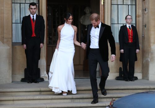 The newly married couple leave Windsor Castle after their wedding to attend an evening reception at Frogmore House, hosted by the Prince of Wales. Picture: PA