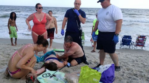 Fellow beachgoers rushed to her aid, using a boogie board line to stem the bleeding. (AAP)