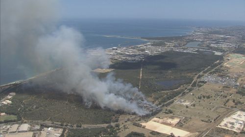 There are 100 firefighters on the scene, trying to contain an out-of-control bushfire threatening lives and homes in the southwest of Perth.