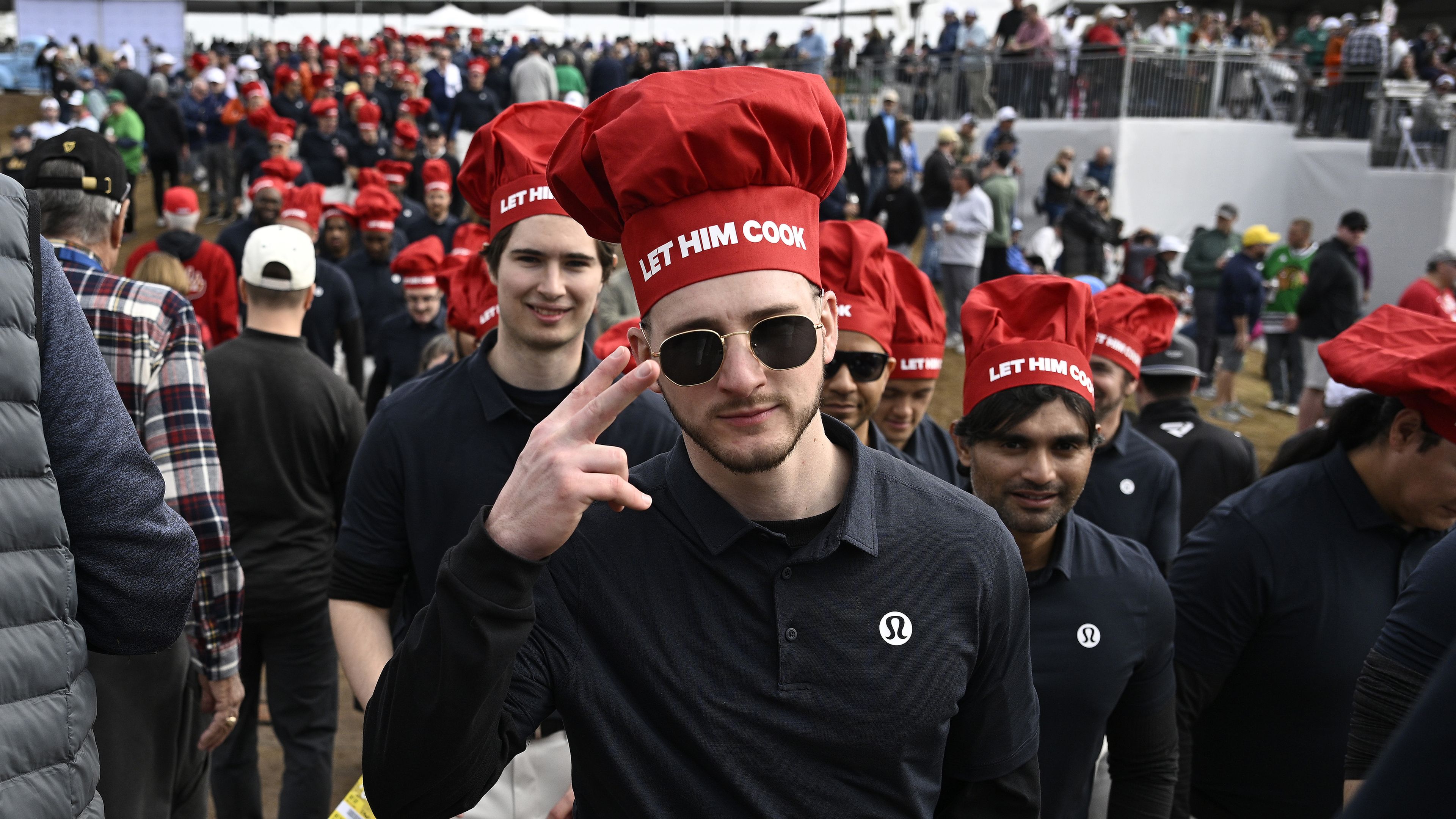 Fans of Aussie Min Woo Lee wear &quot;Let Him Cook&quot; chefs&#x27; hats during his second round at the 2024 Phoenix Open.