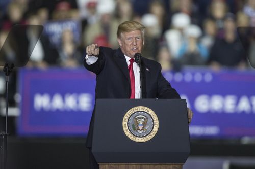 Donald  Trump points at the media members as he talks about "fake news" during a Make America Great Again rally yesterday. (AAP)