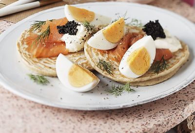 Blinis with hard boiled egg and smoked salmon