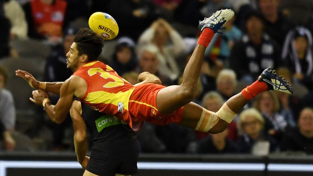 Gold Coast player Aaron Hall attempts to take a mark. (AAP)