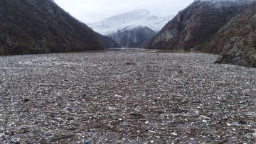 Waste floating in the Drina river near Visegrad, Bosnia, Friday, Jan. 20, 2023. Tons of waste dumped in poorly regulated riverside landfills or directly into the rivers across three Western Balkan countries end up accumulating during high water season in winter and spring, behind a trash barrier in the Drina River in eastern Bosnia. (AP Photo/Armin Durgut)