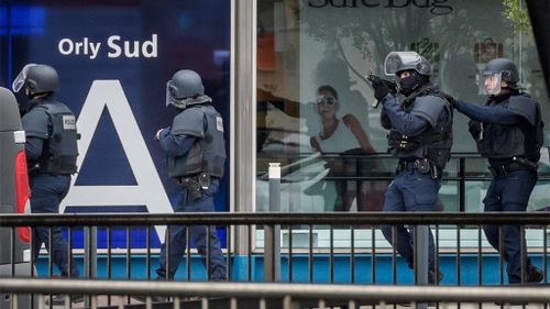 Armed police special intervention units move into position at Orly airport. (AAP)