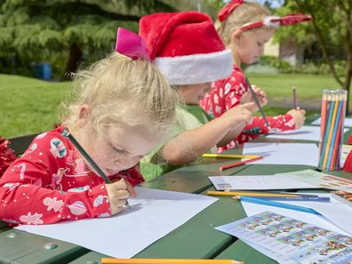 Australia Post kids writing out their Santa Mail. 