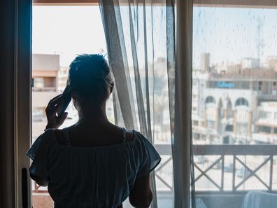 Woman at window during self isolation