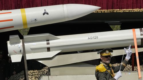 Missiles are carried on a truck as an Iranian army band leader conducts the music band during Army Day parade at a military base in northern Tehran in Iran on Wednesday, April 17 in 2024. 