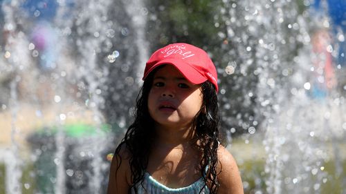 Tennis goers did their best to keep cool on day four of the Australian Open in Melbourne yesterday. (AAP)