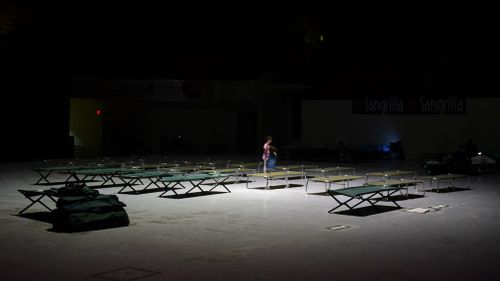 Two girls play on cots at Humacao Arena refugee center while waiting for the imminent impact of Maria. (AP)