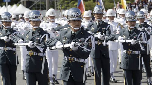 The military honor guard perform during National Day celebrations in front of the Presidential Building in Taipei, Taiwan.