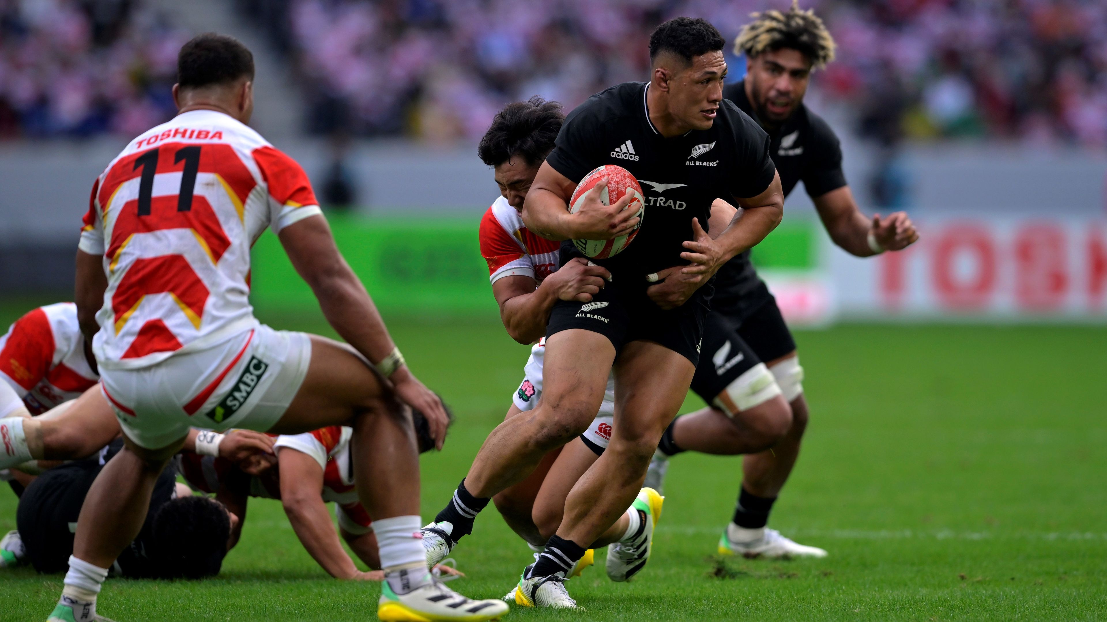 Roger Tuivasa-Sheck is tackled by Ryohei Yamanaka of Japan in their closely fought match at National Stadium in Tokyo.