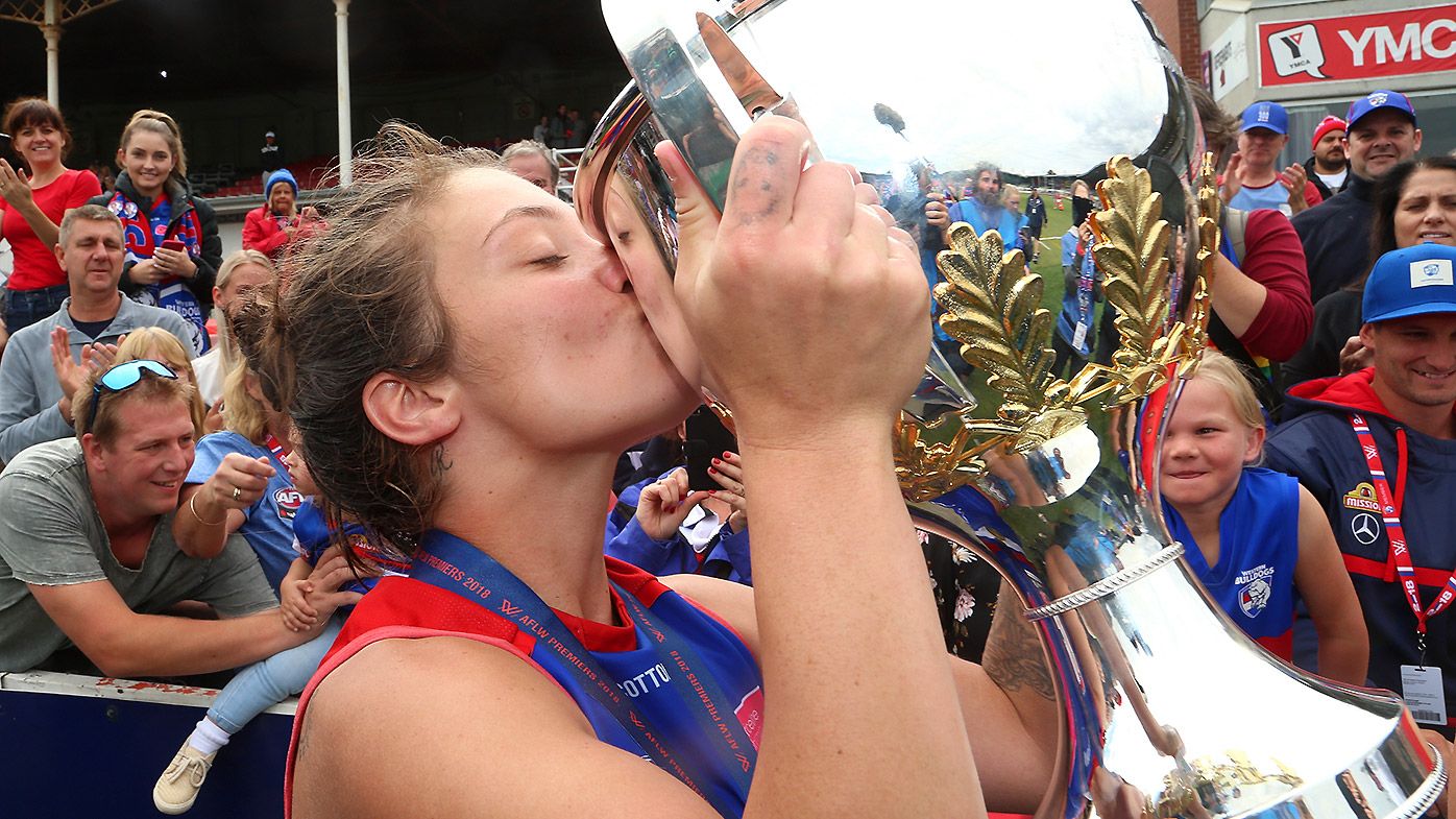 Ellie Blackburn of the Bulldogs celebrates with the trophy