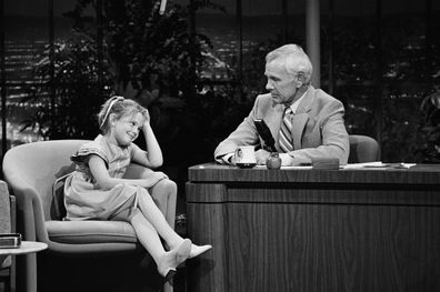 THE TONIGHT SHOW STARRING JOHNNY CARSON -- Air Date 07/28/1982 -- Pictured: (l-r) Actress Drew Barrymore, host Johnny Carson -- Photo by: Gene Arias/NBCU Photo Bank