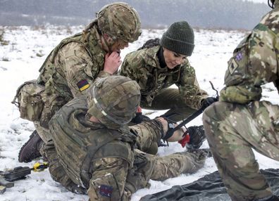 Kate,  Princess of Wales, Colonel, Irish Guards, is shown how to carry out battlefield casualty drills to deliver care to injured soldiers during a casualty simulation exercise, during her first visit to the 1st Battalion Irish Guards since becoming Colonel, at the Salisbury Plain Training Area in Wiltshire, England, Wednesday March 8, 2023. 