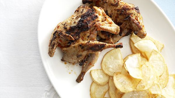 Piri piri quail with chips and tomato and cucumber salad