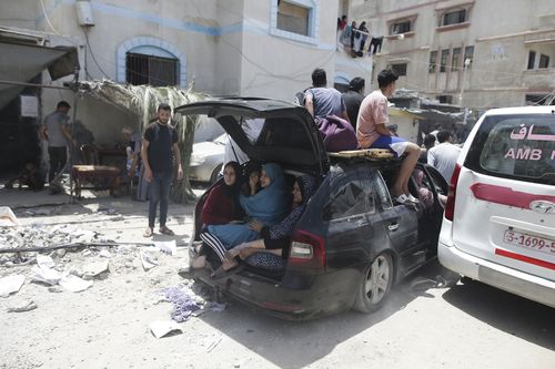 Palestinians evacuate dead and wounded in the Israeli bombardment of the Gaza Strip in Deir al Balah on Saturday, June 8, 2024