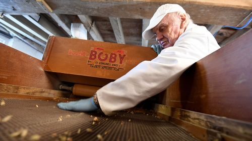 Miller Pete Loosmore checks the winnower at the flour mill.