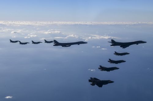 Two US Air Force B-1B bombers, top center, four South Korean Air Force F-35 fighter jets and four US Air Force F-16 fighter jets fly over South Korea Peninsula.
