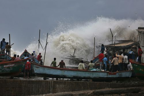 Indian authorities evacuated tens of thousands of people on Wednesday as a severe cyclone in the Arabian Sea approached the western state of Gujarat, lashing the coast with high winds and heavy rainfall. (AP Photo/Ajit Solanki)