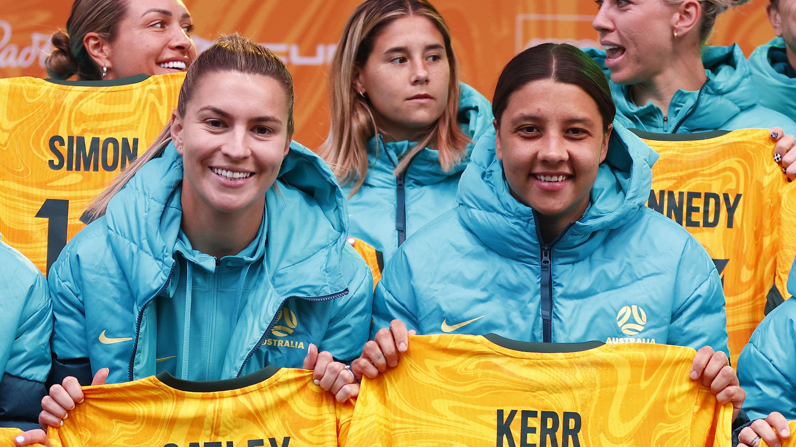 MELBOURNE, AUSTRALIA - JULY 11: Steph Catley of the Matildas (L) and Sam Kerr of the Matildas pose with their jerseys during the Australia Matildas World Cup squad public presentation at Federation Square on July 11, 2023 in Melbourne, Australia. (Photo by Daniel Pockett/Getty Images)