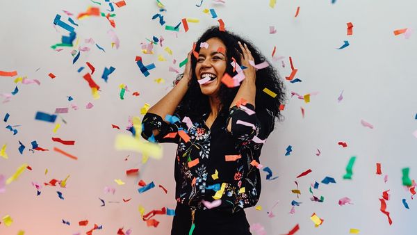 Girl celebrating with confetti.