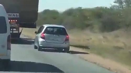 A driver has been filmed attempting to overtake a road train truck on a rural road. Picture: Facebook/Road Trains Australia.