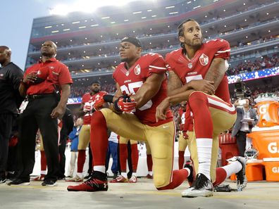 San Francisco 49ers safety Eric Reid (left)) and quarterback Colin Kaepernick kneel during the national anthem before a 2016 NFL football game against the Los Angeles Rams 