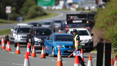 Queensland Police stop vehicles at a Police checkpoint set up at the Queensland and New South Wales border in March on the Gold Coast, Australia. 