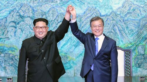 South Korean President Moon Jae In and North Korean leader Kim Jong Un raise their hands after signing a joint statement. (AP)