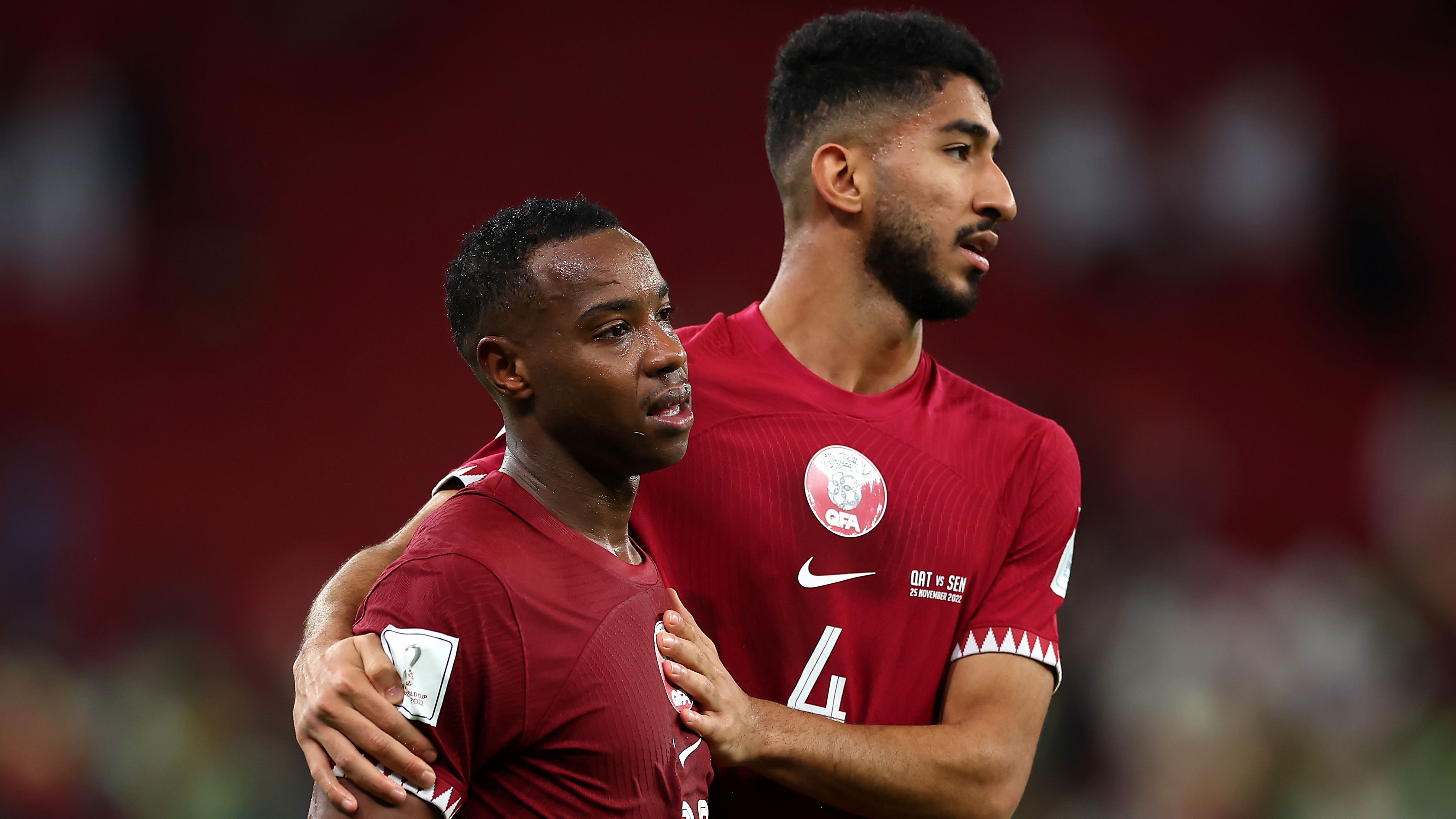 Assim Madibo and Mohammed Waad of Qatar show dejection after their 1-3 defeat in  the FIFA World Cup Qatar 2022 Group A match between Qatar and Senegal at Al Thumama Stadium on November 25, 2022 in Doha, Qatar. (Photo by Alex Grimm/Getty Images)