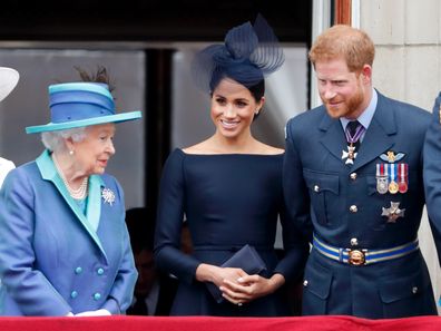 LONDON, UNITED KINGDOM - JULY 10: (EMBARGOED FOR PUBLICATION IN UK NEWSPAPERS UNTIL 24 HOURS AFTER CREATE DATE AND TIME) Queen Elizabeth II, Meghan, Duchess of Sussex and Prince Harry, Duke of Sussex watch a flypast to mark the centenary of the Royal Air Force from the balcony of Buckingham Palace on July 10, 2018 in London, England.